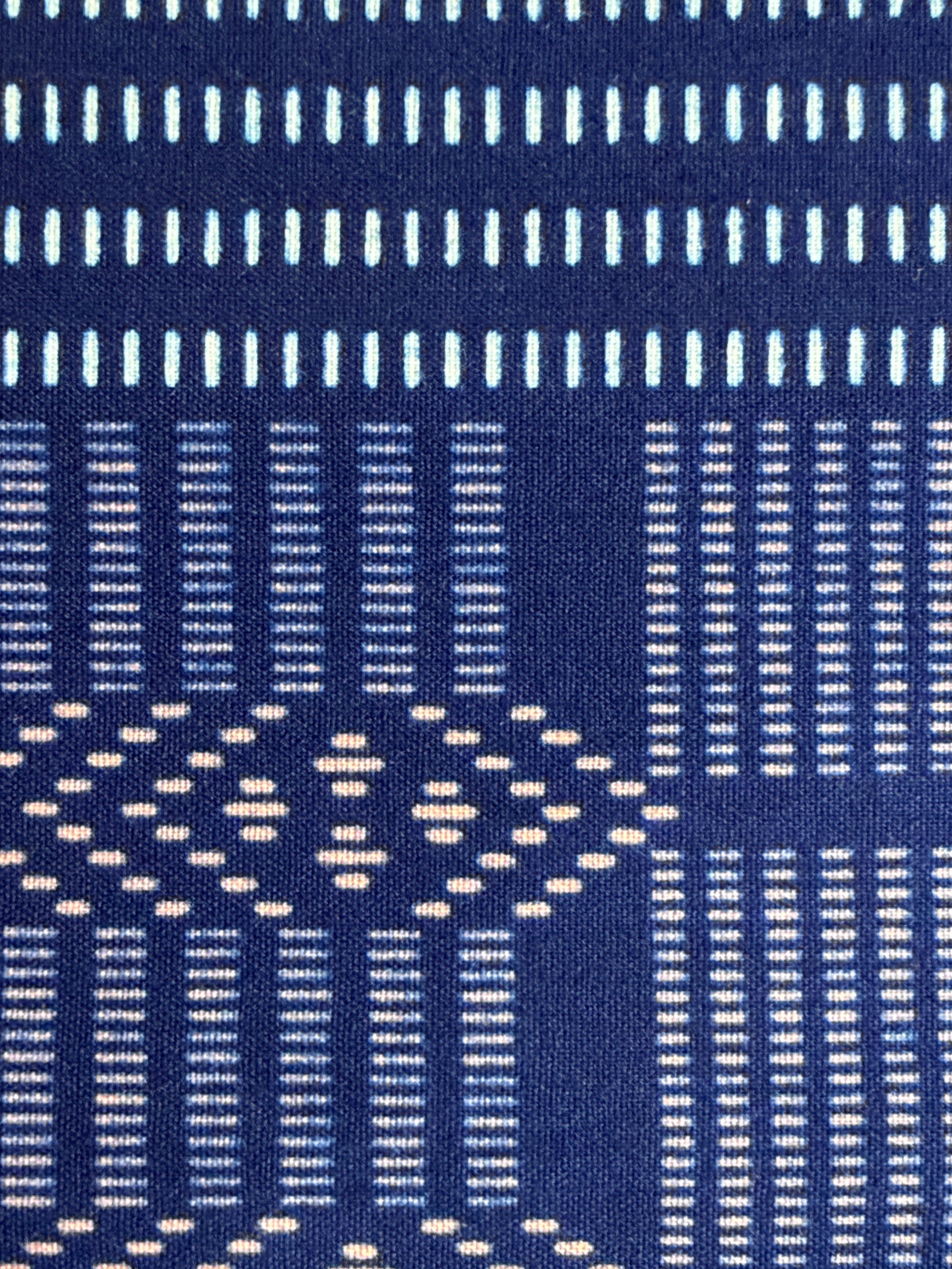 Close-up of a blue fabric with white geometric patterns