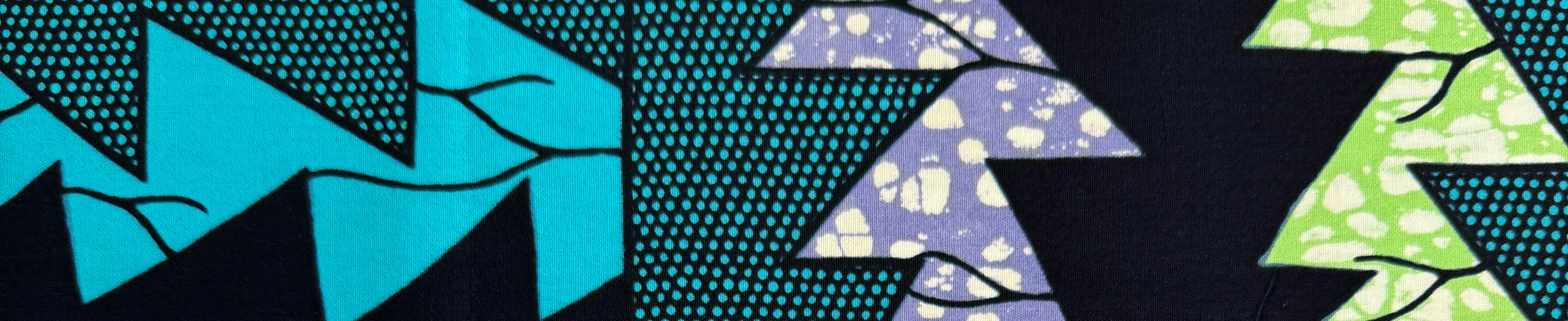 Ankara African print fabric with bold geometric patterns in blue, teal, and purple motifs.