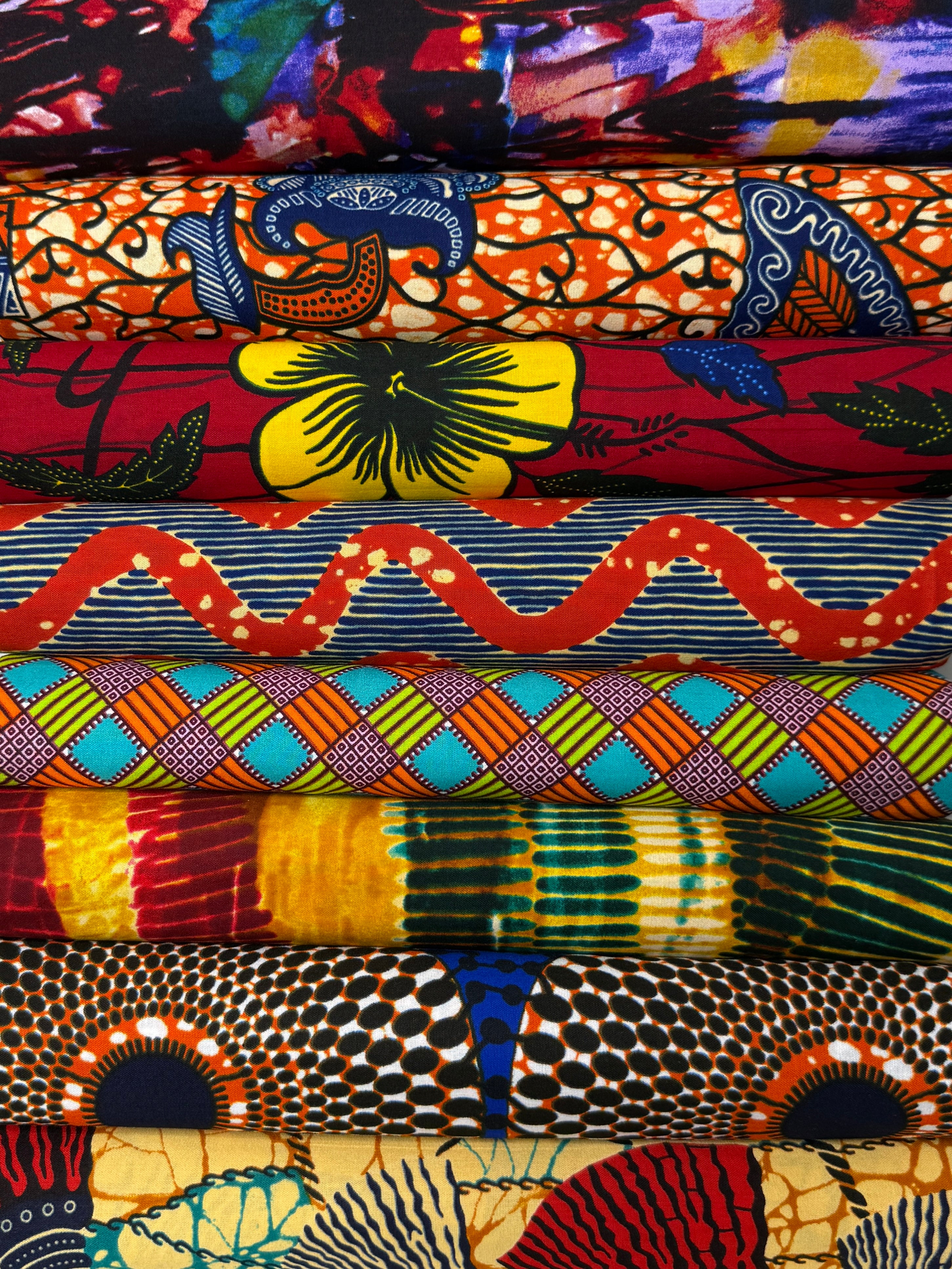 Collection of African fabrics including Ankara, Kente, and Tribal prints available at The African Fabric Shop