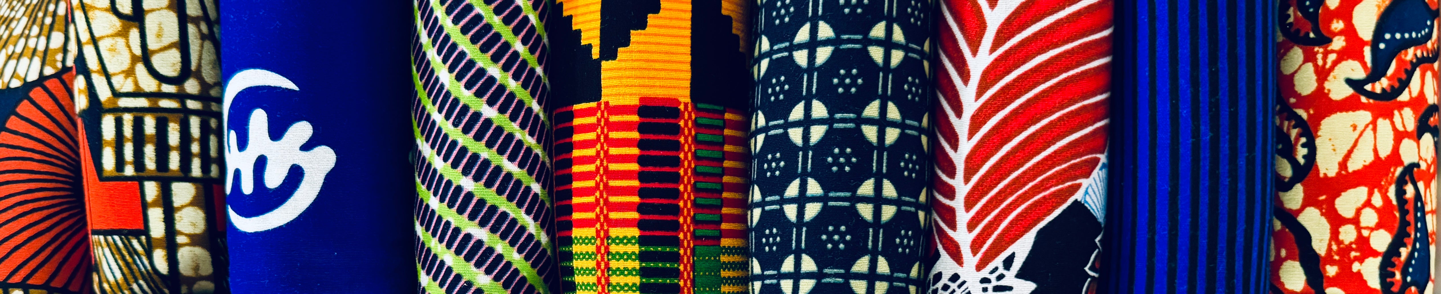 Collection of colorful Ankara, Tribal, and Kente African fabrics sold by the yard.
