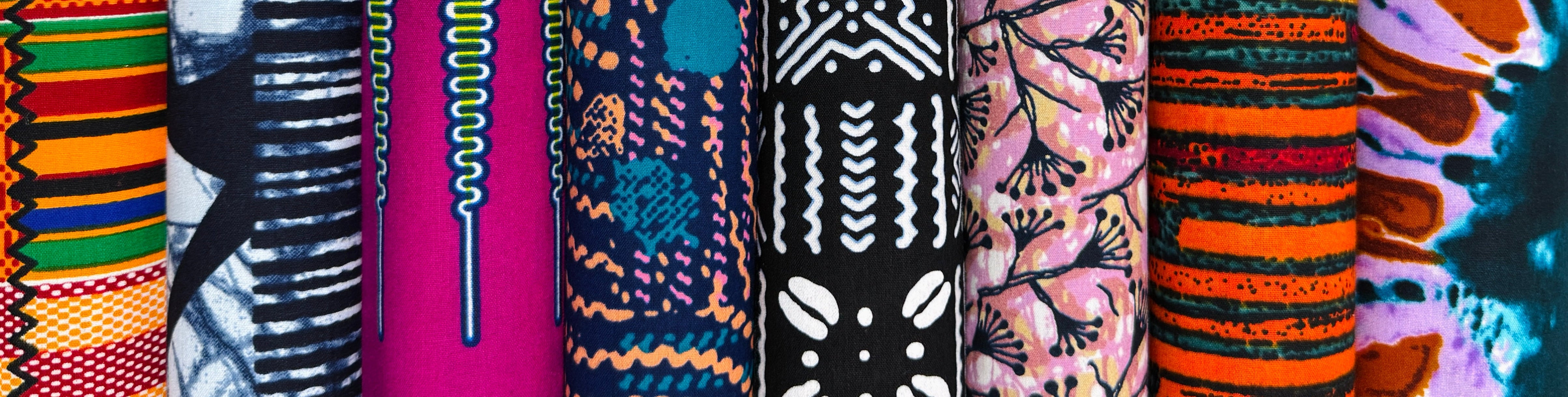 Collection of colorful Ankara, Tribal, and Kente African print fabrics with various patterns.